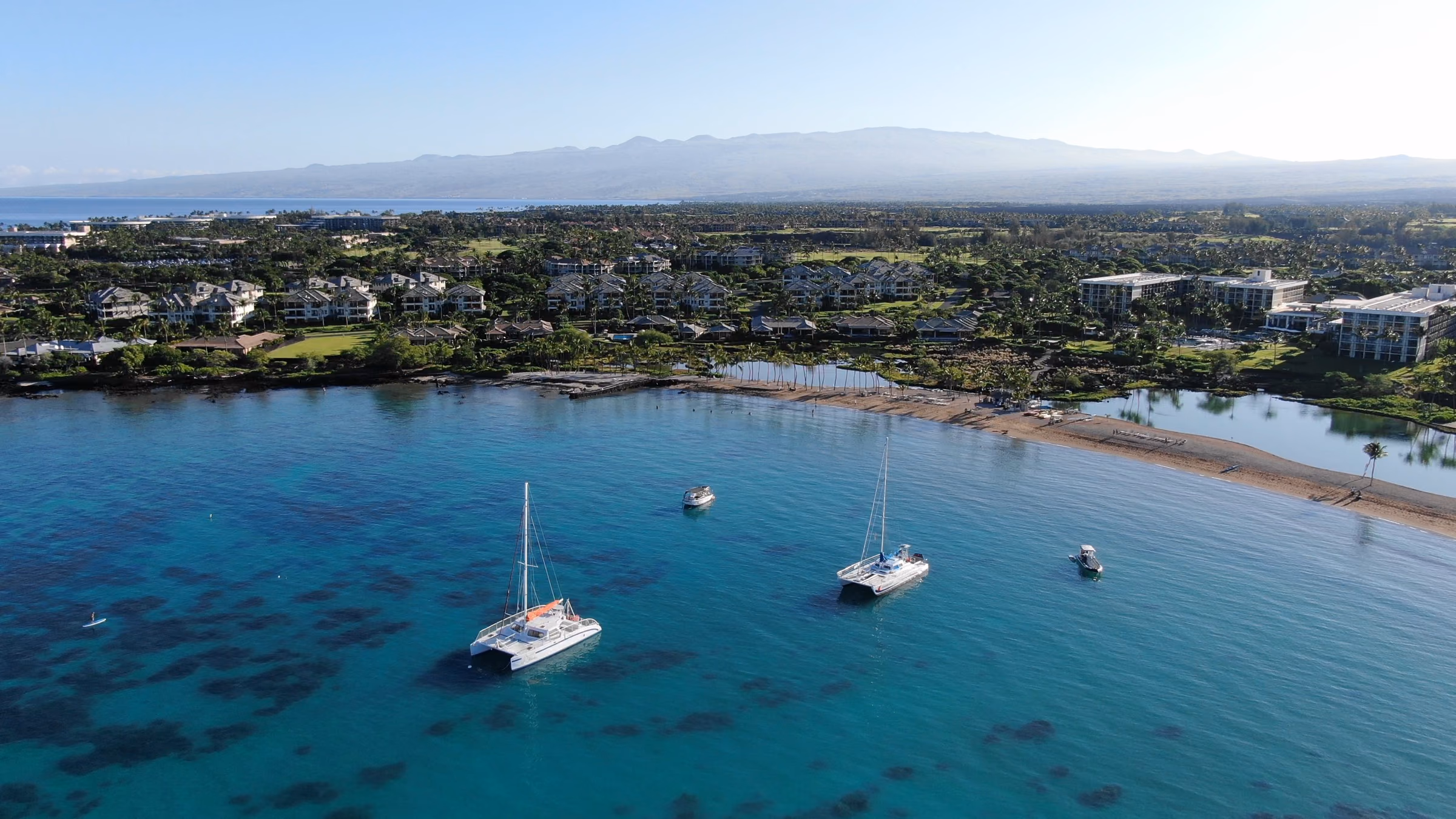 Catamarans anchored in a calm turquoise bay on Hawaiʻi Island