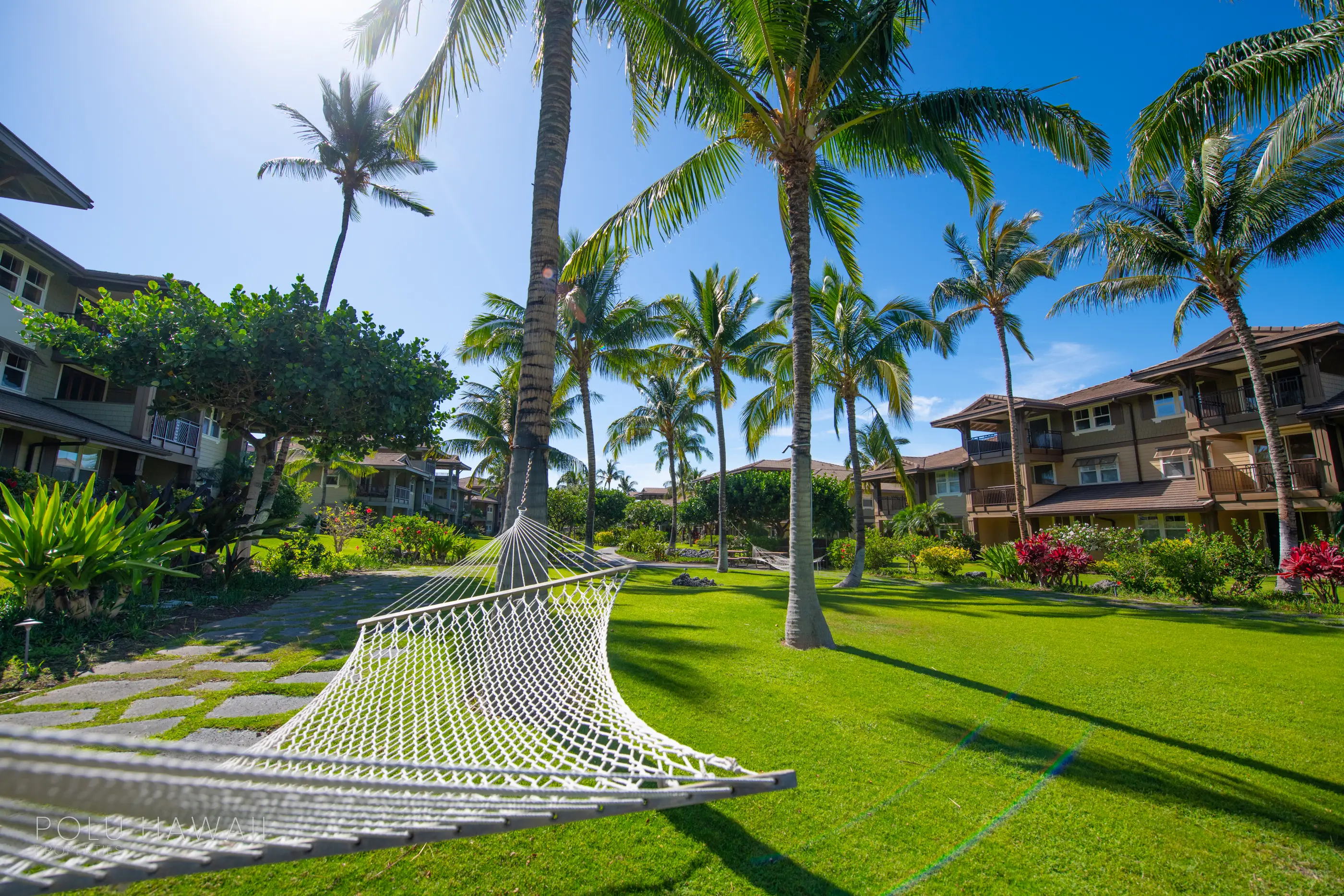 Palm-shaded lawns and hammocks between island-style residences at Haliʻi Kai, Waikoloa Beach Resort