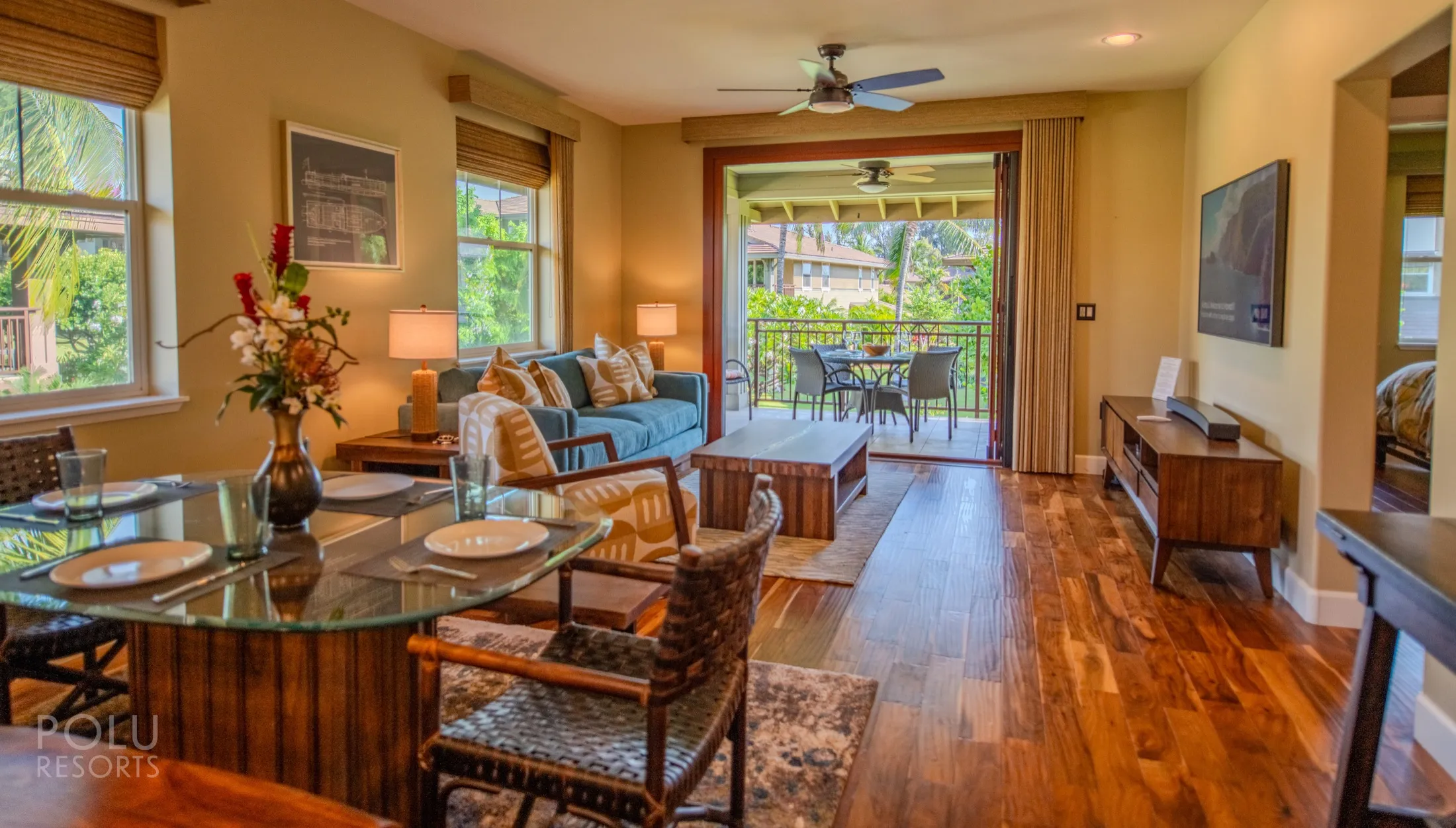 Sunlit, island-styled living room opening onto a private lanai at a Polu Resorts home